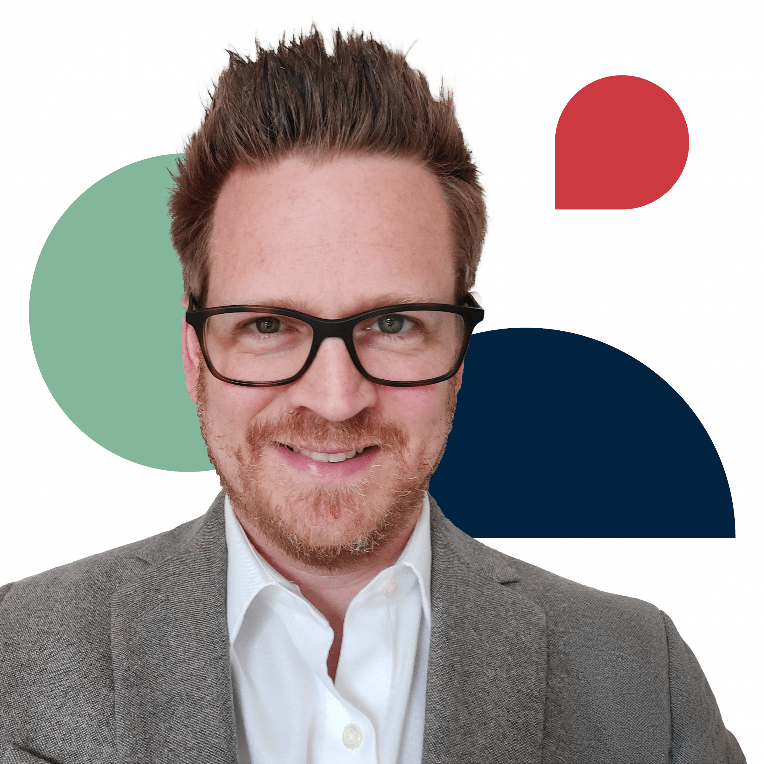 creative director matthew daniel wearing a brown suit jacket with a white button down shirt and he is wearing brown square-framed glasses